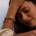 Model showcasing the Intentional Journey Labradorite Lotus Bracelet along with other spiritual bracelets, embracing the essence of meditation and meaningful adornments. Ideal for those seeking protection and wellness through spiritual jewelry.