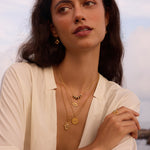 A model wearing the Ignite Strength Garnet Petal Necklace layered with other spiritual jewelry pieces, embodying spiritual protection and meaningful meditation themes, perfect for yoga enthusiasts and zodiac-inspired fashion.