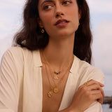 A model wearing the Ignite Strength Garnet Petal Necklace layered with other spiritual jewelry pieces, embodying spiritual protection and meaningful meditation themes, perfect for yoga enthusiasts and zodiac-inspired fashion.