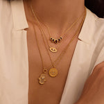 Ignite Intuition White Topaz Evil Eye Necklace showcased in a layered necklace style, emphasizing its spiritual significance as a talisman for protection and intuition. This delicate piece pairs beautifully with other spiritual jewelry, reflecting meanings of manifestation and zodiac energies.