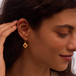 Model showcasing the Strong Heart Garnet Drop Earrings, emphasizing their elegance and connection to spiritual meanings. This jewelry represents love, strength, and new beginnings, fitting perfectly into a lifestyle centered on spirituality and personal growth.