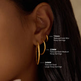 A comparison of Textured Gold Medium Hoop Earrings alongside other sizes, illustrating their 23mm diameter. This image captures the essence of spiritual jewelry, perfect for adding depth to your meditation journey and enhancing your journey of manifestation, protection, and personal meaning.