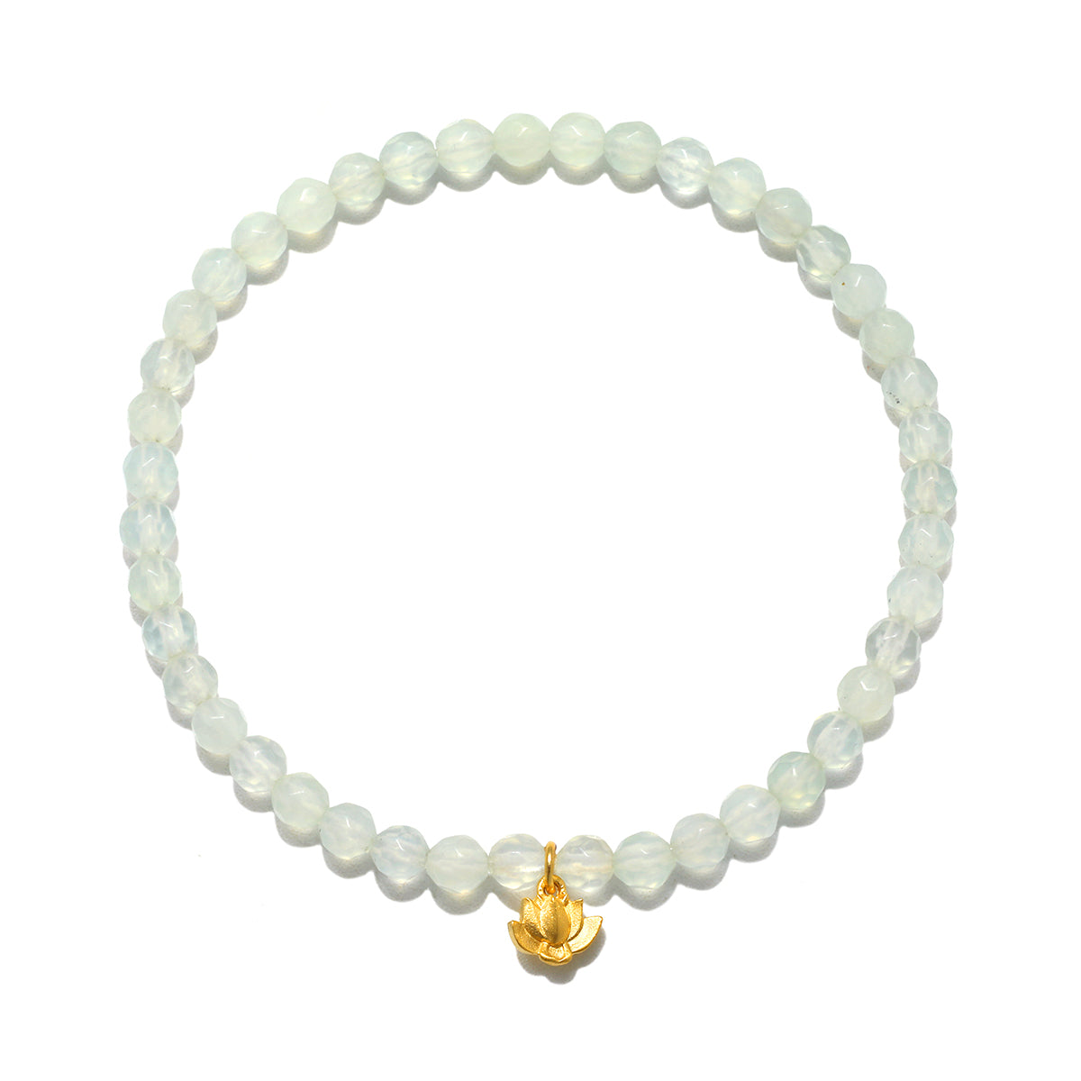 A circular stretch bracelet of small, faceted, pale green translucent beads with a single gold lotus flower charm hanging at the bottom.