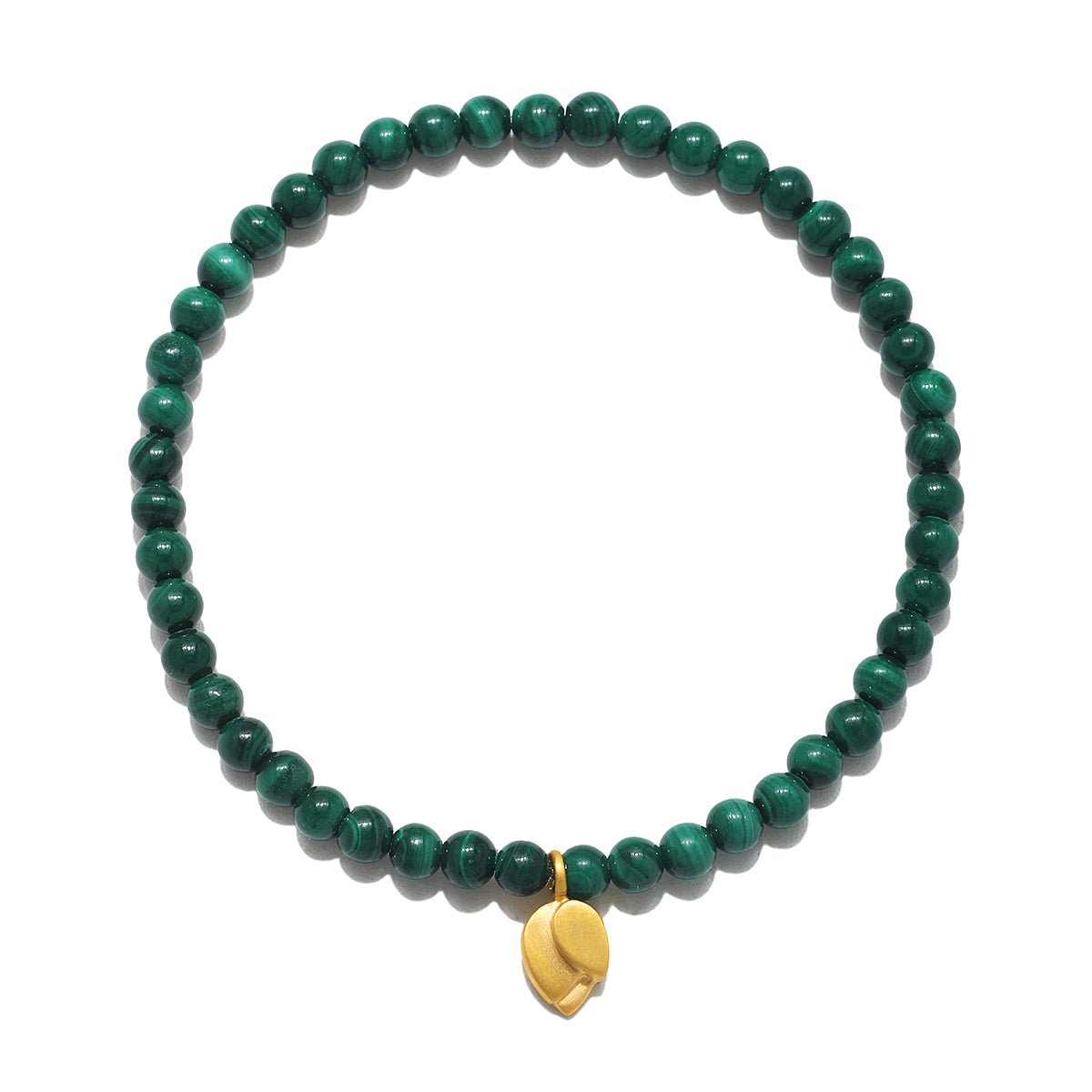 A circular stretch bracelet made of small round green banded malachite beads with a small gold lotus bud charm hanging at the bottom.