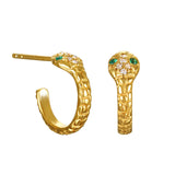 Two gold snake-shaped hoop earrings with scaled texture, green stone eyes, and small clear crystals on the head, shown side and front.