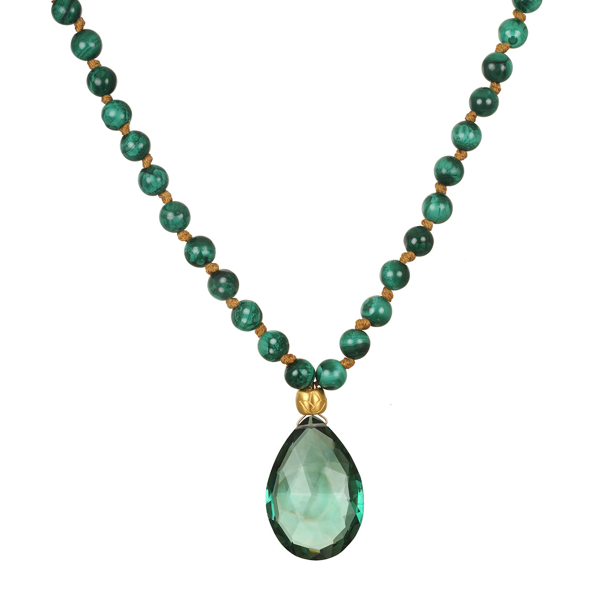 A necklace of round green malachite beads knotted on tan cord holds a faceted teardrop green gemstone pendant with a gold cap.