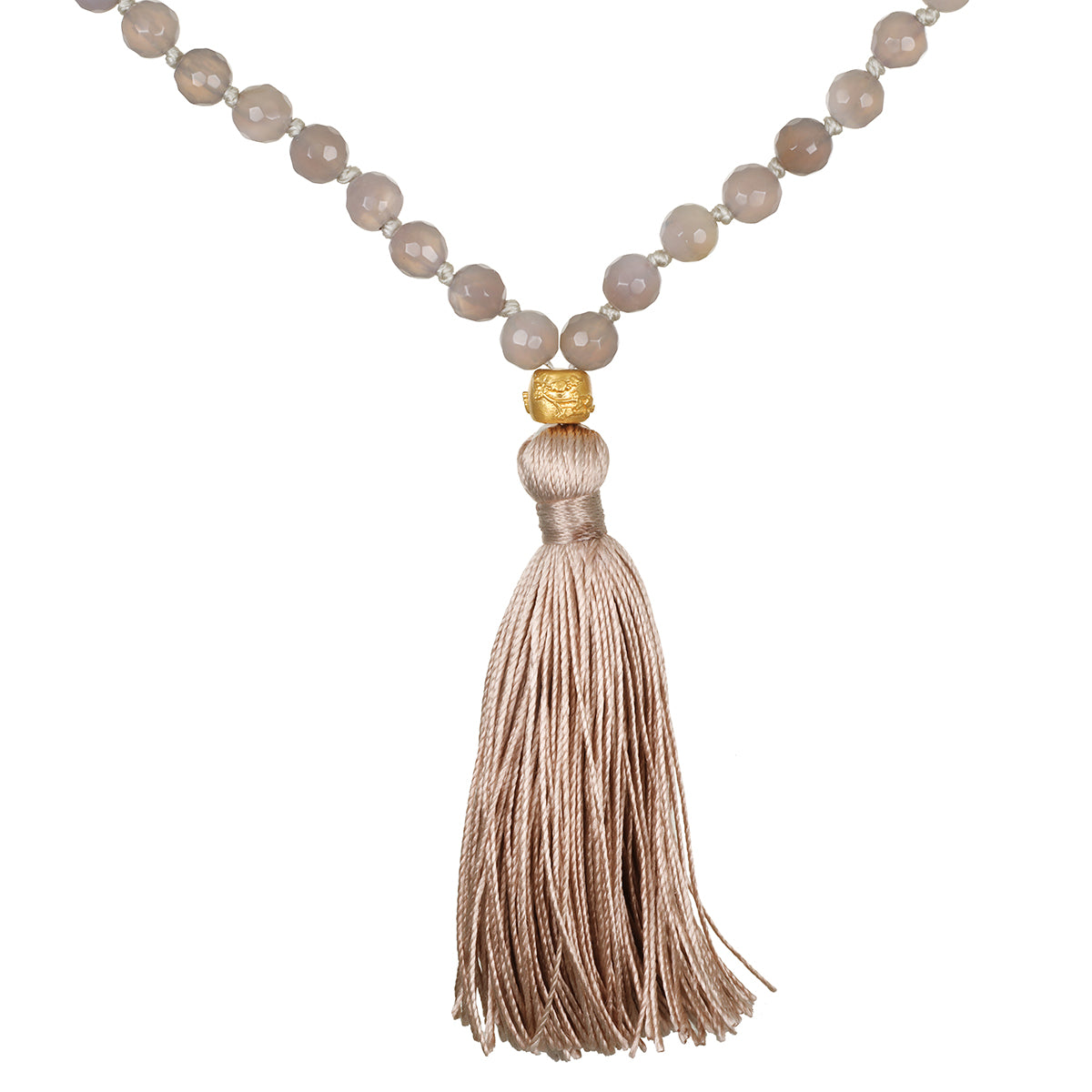 A necklace of faceted grey beads with small knots between them ends in a gold-toned bead and a long taupe silk tassel.