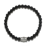 Extended Journey Men's Black Onyx Bracelet featuring a silver 'om' charm, representing spiritual jewelry that enhances meditation and serves as a meaningful talisman. This bracelet is perfect for those seeking protection and harmony in their yoga practice and aligns with the energies of the sun and moon, making it a beautiful manifestation charm.
