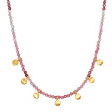 Pink tourmaline beaded necklace with gold-toned coin charms distributed along the strand.