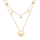 Two-layered gold necklace set with celestial charms including sun, moon, and star pendants with crystal accents.