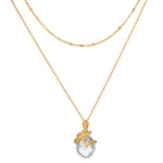 Two-layered gold chain necklaces with faceted clear stone pendant wrapped in textured gold detailing.