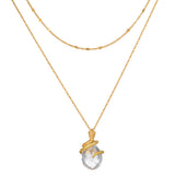 Two-layered gold chain necklaces with faceted clear stone pendant wrapped in textured gold detailing.