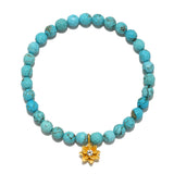 In Transformation Turquoise Gemstone Bracelet featuring a golden lotus flower charm. This spiritual jewelry embodies health, intuition, and self-expression, making it perfect for meditation and yoga practices. A meaningful talisman for manifestation and protection.