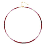 Flat lay of the Shades of Passion 14kt Gold Ruby Necklace showcasing its stunning ombré ruby shades against a light background, illustrating its meaning and significance in spiritual jewelry and meditation.