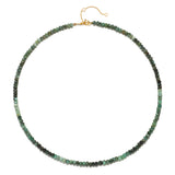The Shades of Wisdom 14kt Gold Emerald Necklace displayed elegantly, showcasing its ombré effect with 4mm faceted rondelle emeralds. This necklace is not only a beautiful piece of spiritual jewelry but also a sacred talisman that embodies the meanings of abundance and mercy, ideal for meditation and enhancing yoga practices.