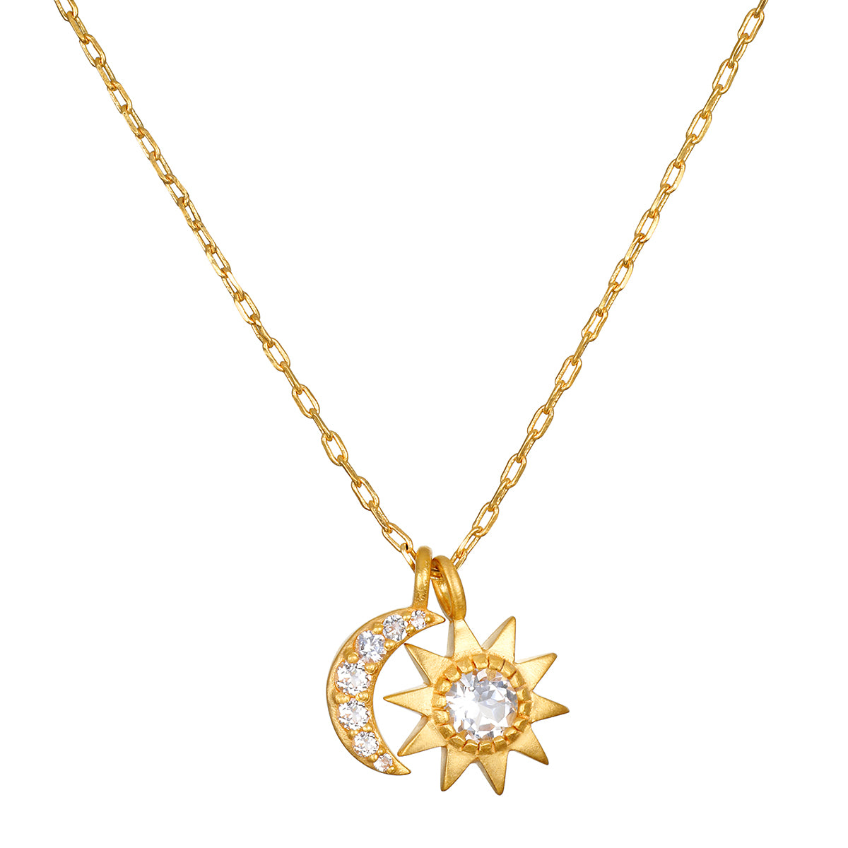 A gold chain necklace with two pendants: a crescent moon set with small clear stones and a pointed sun with a large center stone.