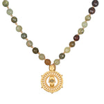 Inhabit Your Power Smokey Quartz Green Garnet Mala featuring 108 smokey quartz and green garnet beads, designed as spiritual jewelry for meditation and as a meaningful talisman. This mala symbolizes protection with its intricate hamsa charm and evil eye made of labradorite, perfect for those practicing yoga and manifestation. Ideal for enhancing spirituality and zodiac connections.
