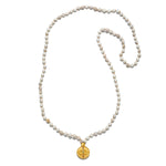 The Aligned in Intention White Turquoise Chakra Mala displayed flat against a clean background, highlighting the 108 white turquoise beads and the stunning gold plate pendant. This spiritual jewelry piece is perfect for enhancing meditation practices and serves as a powerful talisman for protection and meaningful energy flow.