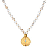 Aligned in Intention White Turquoise Chakra Mala featuring 108 white turquoise beads and a golden pendant. This spiritual jewelry piece promotes meditation and serves as a meaningful talisman for protection and manifestation. Ideal for yoga practitioners, this mala symbolizes balance and aligns with the energies of the chakras for spiritual growth.
