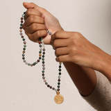 Hands holding the Beacon of Creativity Fancy Jasper Celestial Mala, emphasizing its beauty as a charm for meditation and a powerful symbol of creativity, protection, and manifestation.