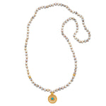 Step Into Self White Opal Mandala Mala featuring 108 white opal beads and an 18kt gold plated mandala pendant with turquoise. This beautiful piece of spiritual jewelry is perfect for meditation and serves as a meaningful talisman for protection and manifestation. Ideal for yoga enthusiasts and those seeking clarity and balance in their spiritual journey.