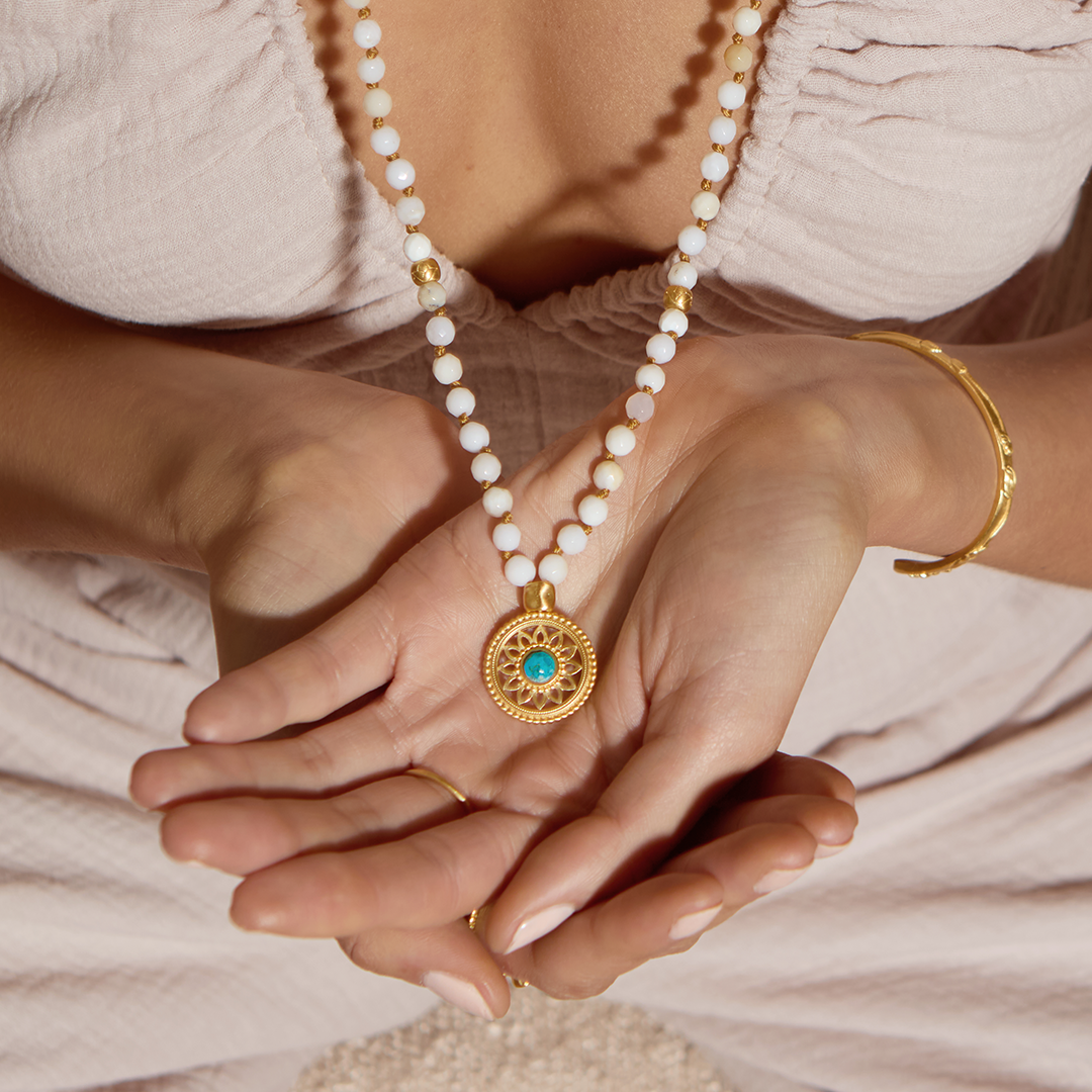 Close-up of the Step Into Self White Opal Mandala Mala held in hands, showcasing the intricate mandala pendant and white opal beads, a meaningful piece for spiritual practices, protection, and personal charm during meditation.