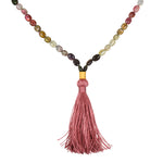 Peaceful Spirit Tourmaline Gemstone Mala featuring vibrant multi-colored tourmaline beads and a soft pink tassel, ideal for meditation and spiritual practices. This talisman supports manifestation, making it a meaningful accessory for yoga and zodiac rituals, providing protection and enhancing your spiritual journey.