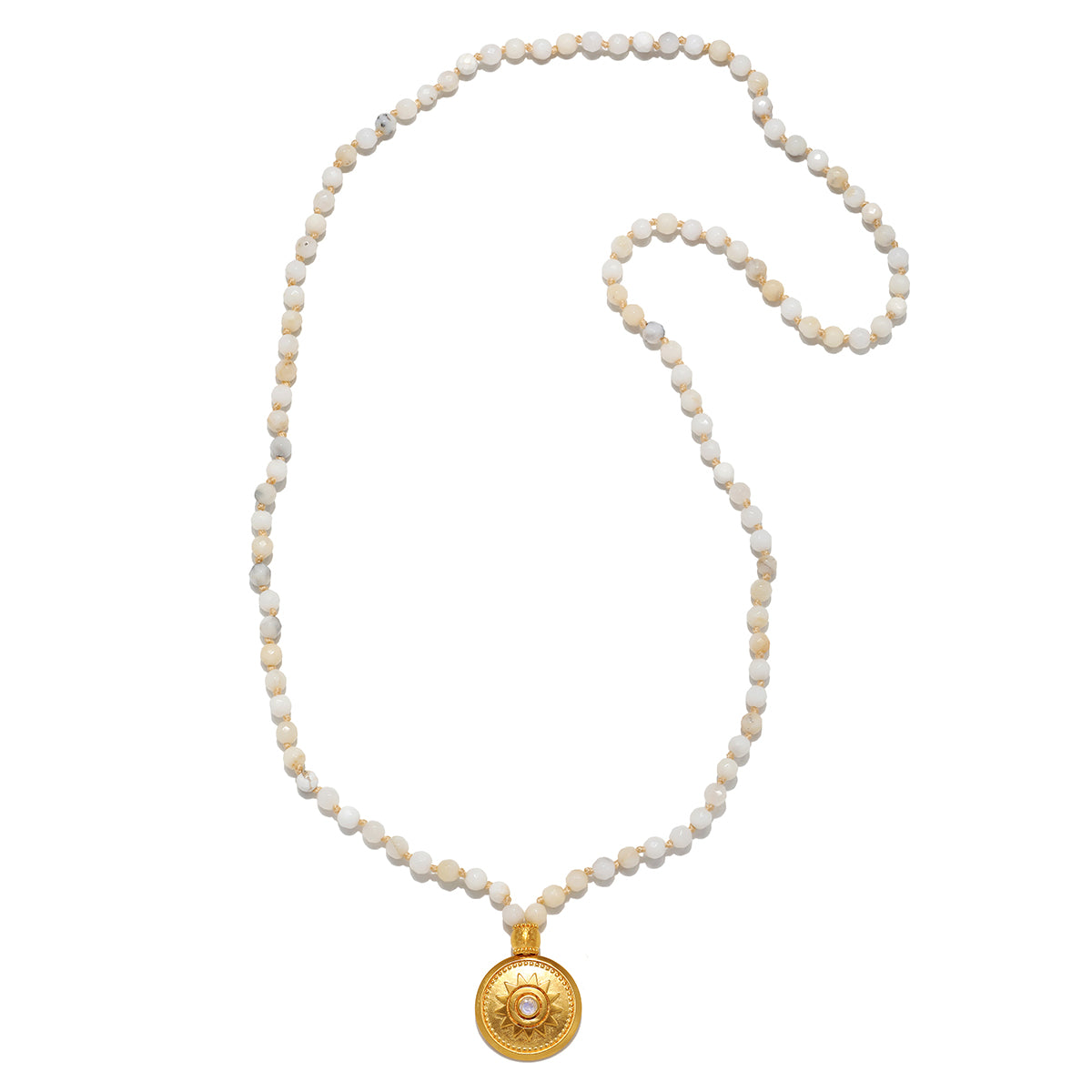 The Tranquil Dawn White Opal Sun Mala laid flat, showing off the elegant arrangement of white opal beads and the golden sun pendant, connecting to themes of spirituality, protection, and meaningful talisman wear.