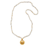 The Tranquil Dawn White Opal Sun Mala laid flat, showing off the elegant arrangement of white opal beads and the golden sun pendant, connecting to themes of spirituality, protection, and meaningful talisman wear.