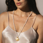 A serene image of the Tranquil Dawn White Opal Sun Mala being worn, displaying its beauty and significance as a talisman for manifestation and healing energies.