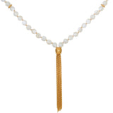 Beaded mala necklace with white mother of pearl spheres separated by gold spacers and gold tassel pendant.