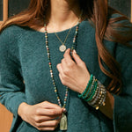 A model showcasing the Grounding Fancy Jasper Gemstone Mala paired with additional spiritual jewelry pieces, exuding a sense of peace and connection. This beautiful mala is perfect for yoga and meditation, representing meaningful practices for spiritual growth and protection.