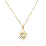 North Star Blue Topaz Starburst Necklace featuring a luminous blue topaz set in an 18kt gold plated starburst, perfect for spiritual jewelry and meditation, symbolizing protection and meaningful manifestation.