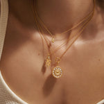 Close-up of the Inward Journey Pearl Mandala Necklace draped elegantly on a neck, emphasizing its unique mandala design and spiritual significance. This luxurious piece serves as a talisman for protection and clarity during meditation, reflecting the golden sun and meaningful practices.