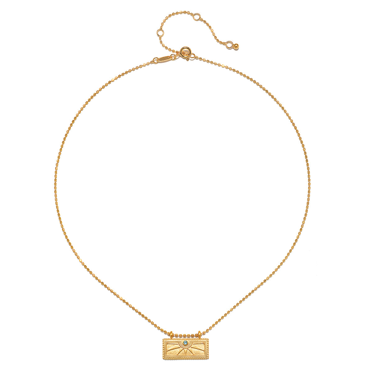 Elegant December Blue Topaz Sunburst Birthstone Tablet Necklace displayed on a white background. This 18kt gold plated piece symbolizes vitality and life, making it a beautiful addition to spiritual jewelry collections. Ideal for meditation enthusiasts seeking charm and meaning from their zodiac signs.