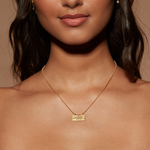 Close-up view of a model wearing the October Pink Tourmaline Sunburst Birthstone Tablet Necklace, radiating charm and elegance. This piece embodies spiritual meaning and is ideal for those seeking a talisman that connects with the sun and zodiac energies during yoga practices.