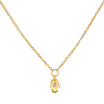 Guiding Hand Mini Hamsa Necklace featuring an 18kt gold plated pendant, ideal for spiritual jewelry and meditation. This talisman promotes protection and embodies meaningful qualities associated with zodiac signs. Perfect for yoga practitioners and those focused on manifestation, this necklace is a charming addition to any collection.
