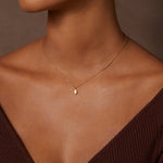 Close-up of a model wearing the Guiding Hand Mini Hamsa Necklace, showcasing the delicate design and labradorite accent. This spiritual jewelry piece is perfect for meditation and brings protection, making it a meaningful charm for enhancing one's spiritual journey.