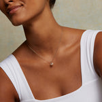 Close-up of the Mini All-Seeing Eye 14kt Gold Diamond Necklace worn by a model, highlighting its detailed design. This spiritual jewelry piece is perfect for those seeking a meditation talisman with protective qualities and meaningful connections to the charm of spiritual practices.