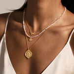 A model wearing the Beauty of Transformation Lotus Petal Necklace layered with additional spiritual jewelry, showcasing its delicate lotus petal design symbolizing new beginnings and manifestation. Perfect for yoga and meditation enthusiasts seeking meaningful adornments.