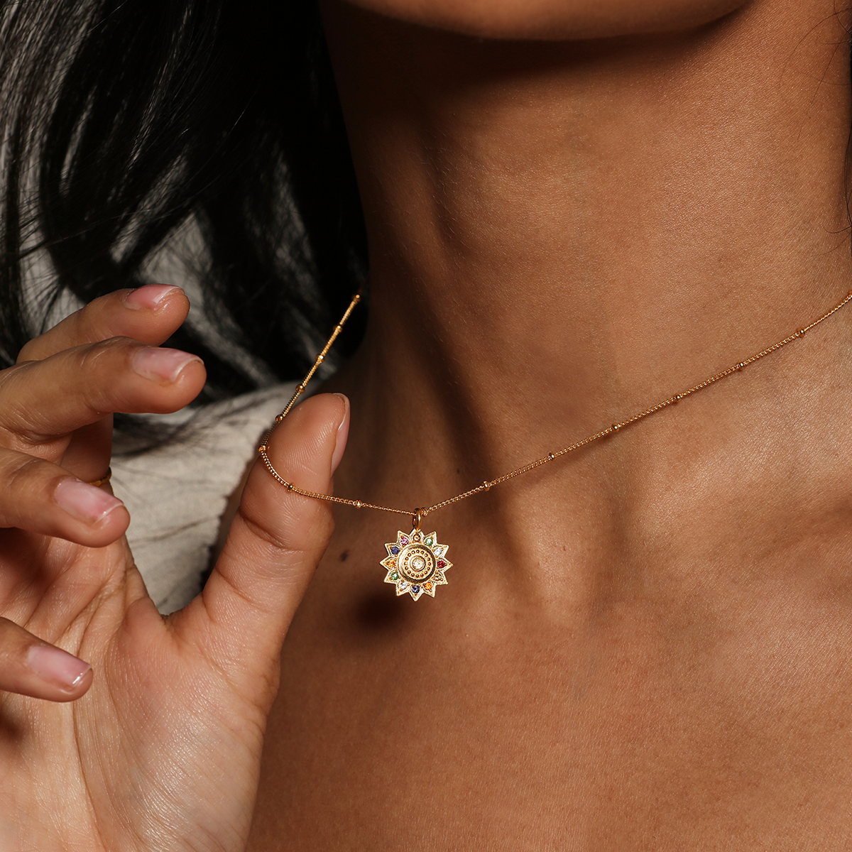 Close-up of a woman wearing the Vibrant Self Multi Stone Lotus Necklace, showcasing the gold-plated lotus pendant, embodying spiritual jewelry and reflecting themes of meditation, protection, and meaningful manifestation.