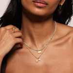 Model showcasing the Manifesting Possibilities Lotus White Topaz Necklace layered with other spiritual jewelry, embracing the essence of manifestation and individuality. A perfect charm for yoga practitioners and those exploring zodiac meanings in their spiritual journey.