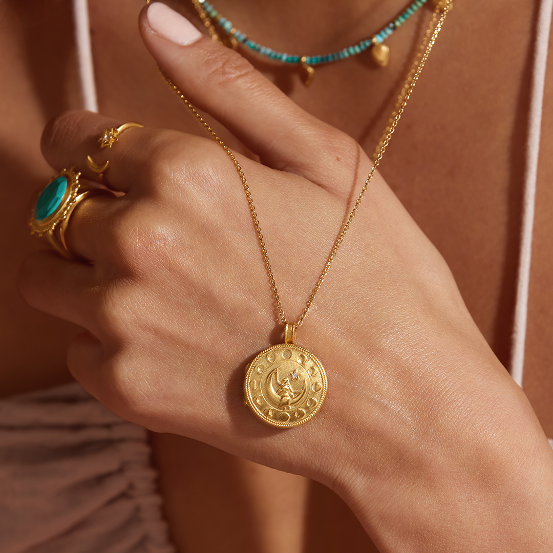 Close-up of the Mother Moon Gold Locket Necklace worn by a model, highlighting its charm and significance in spiritual practices, ideal for those interested in spirituality, talismans, and zodiac meanings.