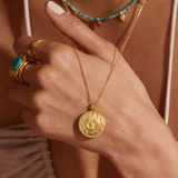 Close-up of the Mother Moon Gold Locket Necklace worn by a model, highlighting its charm and significance in spiritual practices, ideal for those interested in spirituality, talismans, and zodiac meanings.