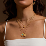 A close-up of the Nurture Intuition Turquoise Mandala Necklace layered with other gold necklaces, showcasing the charm and beauty of spiritual jewelry designed for yoga, protection, and personal expression.