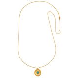The Nurture Intuition Turquoise Mandala Necklace displayed elegantly, showcasing its detailed design in 18kt gold plate. This piece of spiritual jewelry is ideal for meditation and represents balance and meaning in one's life. A perfect charm for those on a journey of self-exploration, enhancing protection, and connecting with the zodiac.