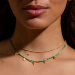 Model wearing the Twinkling Light Gold Choker Necklace layered with gemstone beads, emphasizing its role as spiritual jewelry that inspires manifestation, connection to the sun and moon, and a meaningful accessory for yoga and meditation.