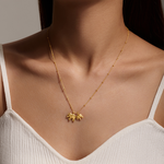 A close-up view of the Elephant Love Gold Necklace showcasing its delicate design, featuring two gold elephants. This spiritual jewelry is ideal for those seeking protection and meaningful adornments during their yoga practice or meditation, symbolizing wisdom and love as a part of their personal charm.