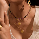 Close-up of the Prosperous Blessings Lakshmi Necklace paired with colorful beads, highlighting its delicate design. This spiritual jewelry is ideal for yoga enthusiasts seeking a meaningful connection to the energies of prosperity and manifestation.