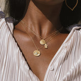 The Favored by Fortune Ganesha Necklace worn alongside other layers, highlighting the spiritual jewelry's elegance and its connection to meditation, talisman, and meaningful manifestation.